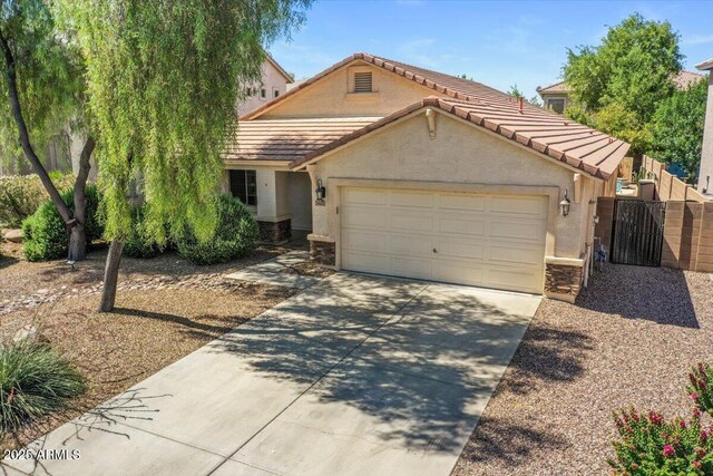 45131 W Horse Mesa Rd, Maricopa, AZ 85139 - view of front of home featuring stucco siding, driveway, a garage, a tile roof, and stone siding