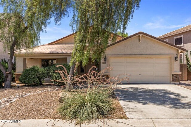 45131 W Horse Mesa Rd, Maricopa, AZ 85139 - view of front of house featuring an attached garage, stucco siding, concrete driveway, and a tile roof