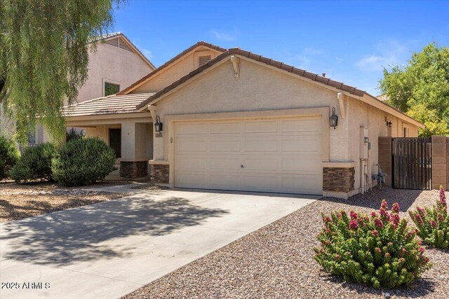 45131 W Horse Mesa Rd, Maricopa, AZ 85139 - view of front of house with stone siding, an attached garage, and stucco siding