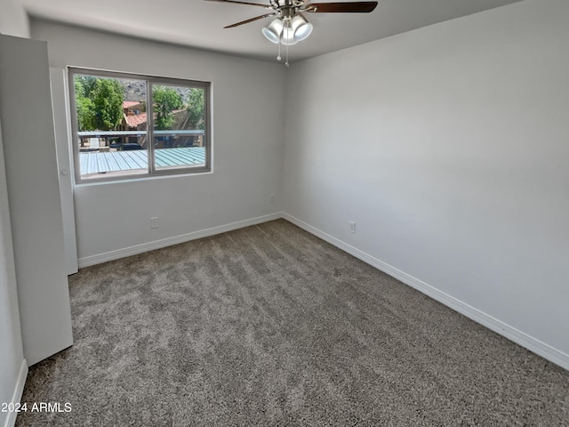 empty room featuring ceiling fan and carpet floors