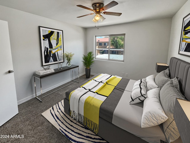 bedroom with ceiling fan and dark carpet