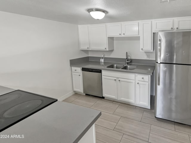 kitchen with white cabinetry, sink, a textured ceiling, and appliances with stainless steel finishes