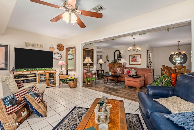 living room featuring light hardwood / wood-style flooring and ceiling fan with notable chandelier