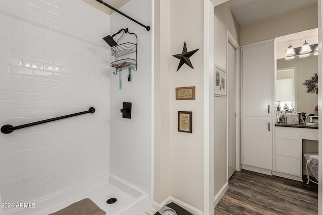 bathroom featuring vanity, tiled shower, and hardwood / wood-style floors