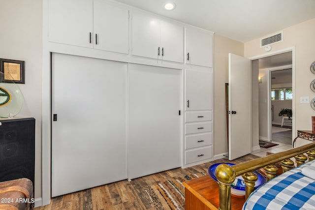 bedroom with a closet and dark wood-type flooring