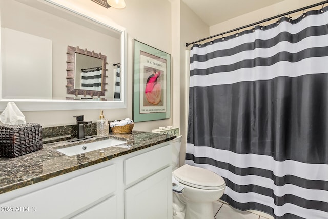 bathroom featuring vanity, toilet, and tile patterned flooring