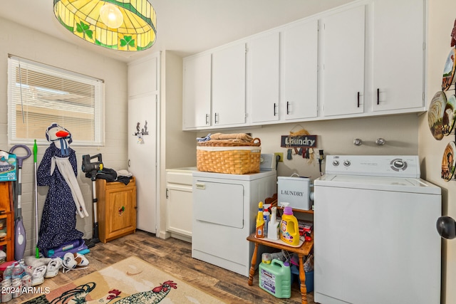 washroom with washer and dryer, dark hardwood / wood-style floors, and cabinets