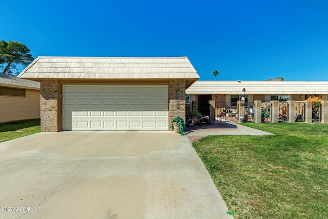 view of front of house featuring a garage and a front lawn