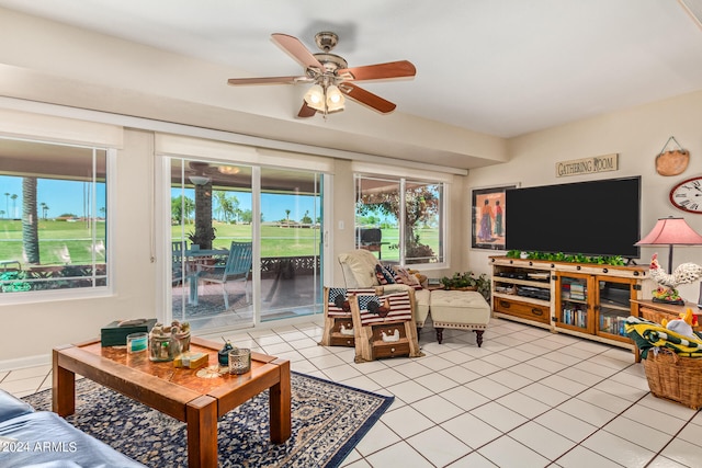 living room featuring ceiling fan, light tile patterned flooring, and a wealth of natural light