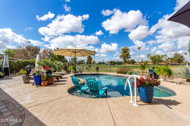 view of pool featuring a patio area, a fenced in pool, and fence