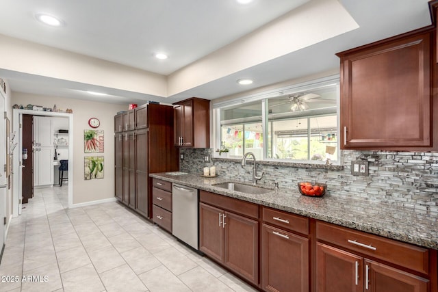 kitchen featuring a sink, stone countertops, stainless steel dishwasher, and decorative backsplash