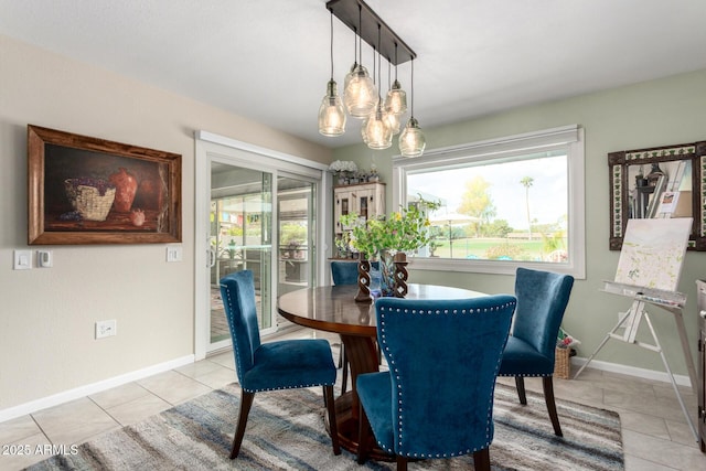 dining room featuring light tile patterned floors, baseboards, and an inviting chandelier