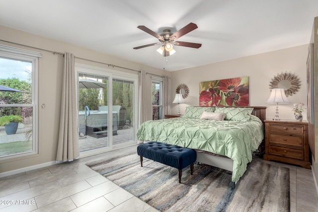 tiled bedroom with access to exterior, ceiling fan, and baseboards