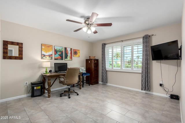 office area featuring a ceiling fan and baseboards