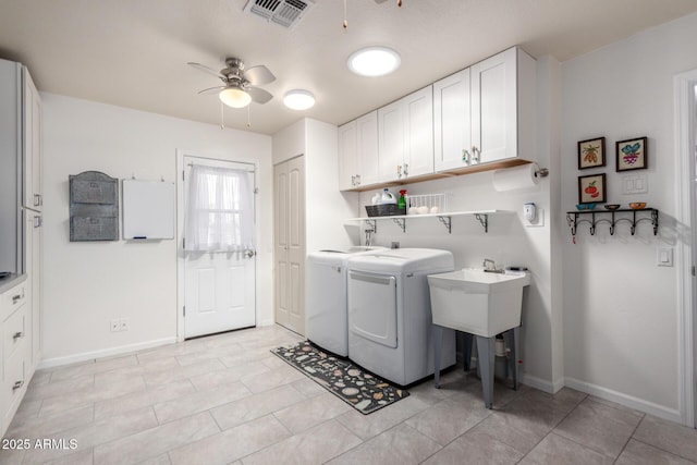 clothes washing area with baseboards, visible vents, cabinet space, ceiling fan, and independent washer and dryer