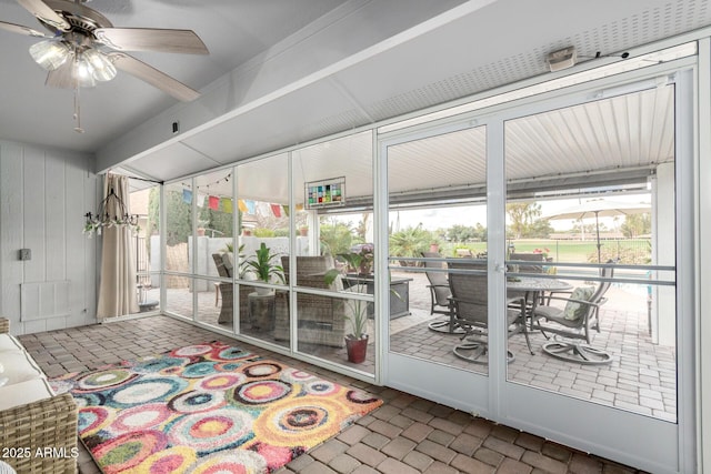 sunroom featuring a ceiling fan