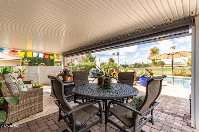 view of patio / terrace featuring outdoor dining space, a fenced in pool, and fence