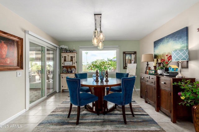 dining space with light tile patterned floors and baseboards