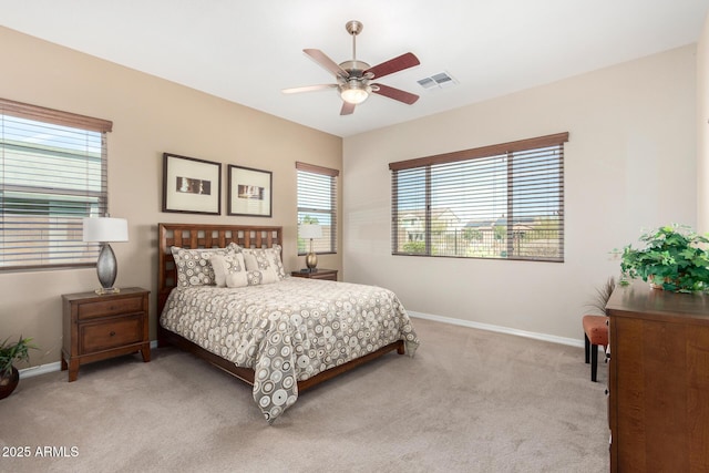 bedroom featuring light colored carpet and ceiling fan