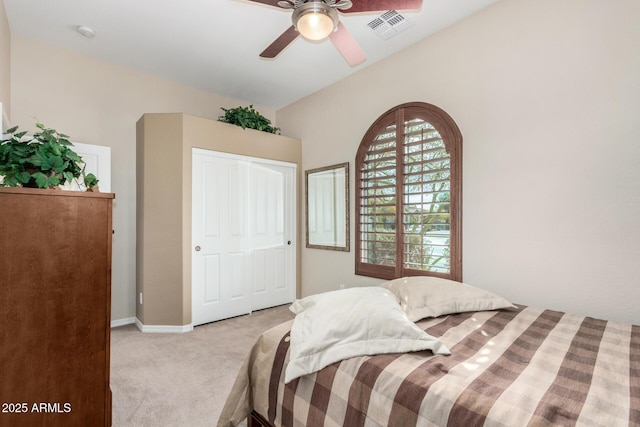 bedroom featuring ceiling fan, a closet, and light carpet