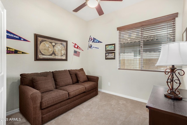 carpeted living room with ceiling fan