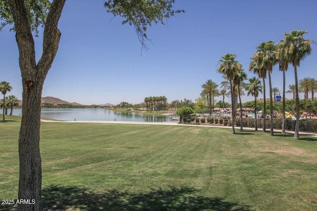 view of community featuring a water view and a lawn