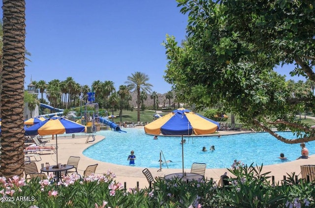 view of pool featuring a playground and a water slide