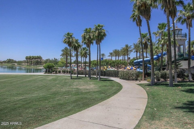 view of community featuring a water view and a lawn