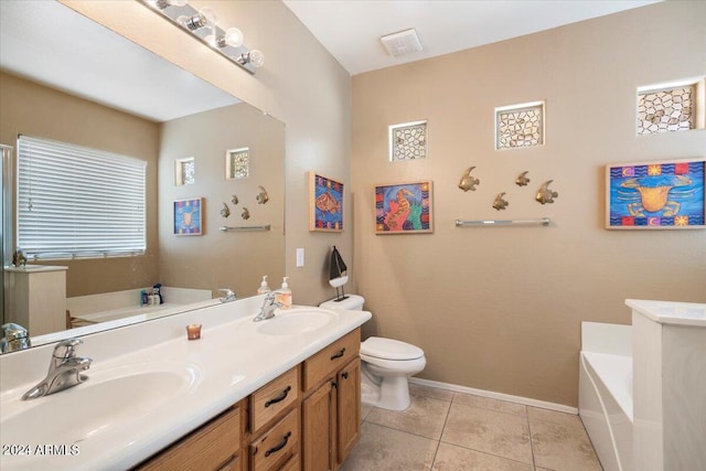 bathroom with vanity, a bathtub, toilet, and tile patterned floors