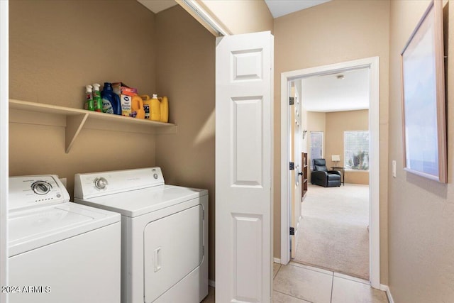 laundry room featuring washer and clothes dryer and light tile patterned floors