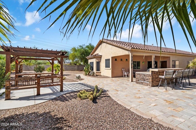 exterior space with a pergola and exterior bar