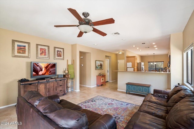 living room featuring ceiling fan and light tile patterned flooring