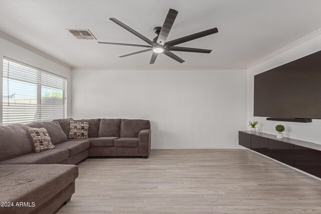 living room with ceiling fan, ornamental molding, and light hardwood / wood-style flooring