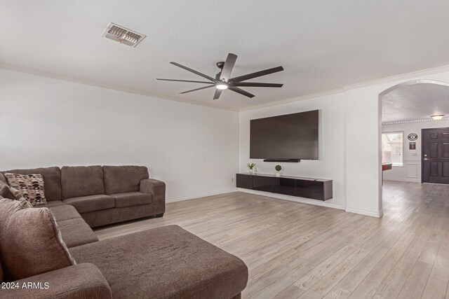 living room featuring crown molding, ceiling fan, and light hardwood / wood-style floors