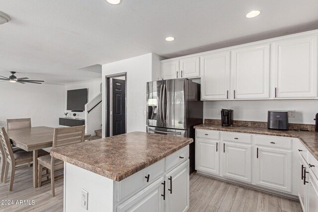 kitchen with white cabinets, ceiling fan, stainless steel fridge with ice dispenser, and light hardwood / wood-style flooring