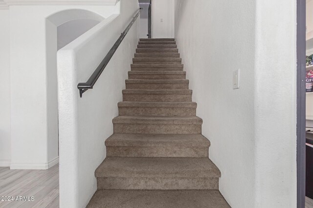 stairs featuring hardwood / wood-style flooring