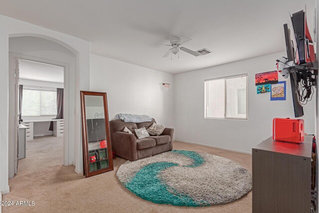 sitting room with carpet and ceiling fan