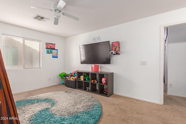 recreation room with ceiling fan and carpet floors