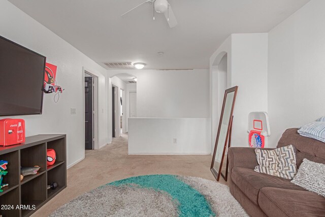 carpeted living room featuring ceiling fan