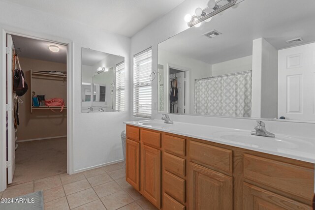 bathroom with tile patterned flooring and vanity