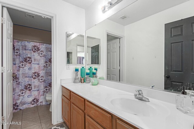 bathroom featuring tile patterned floors, toilet, and vanity