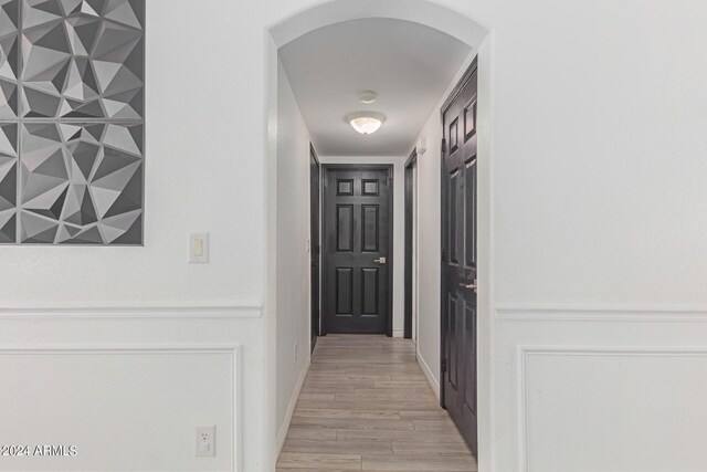 corridor with light hardwood / wood-style flooring