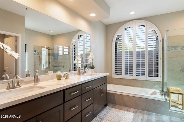 bathroom featuring separate shower and tub and vanity