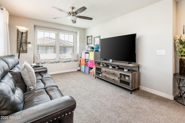 living room with a ceiling fan, carpet flooring, and baseboards