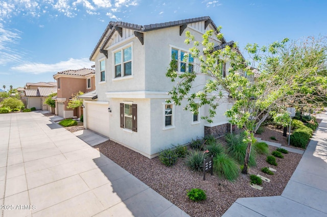 view of property exterior with a garage, concrete driveway, and stucco siding