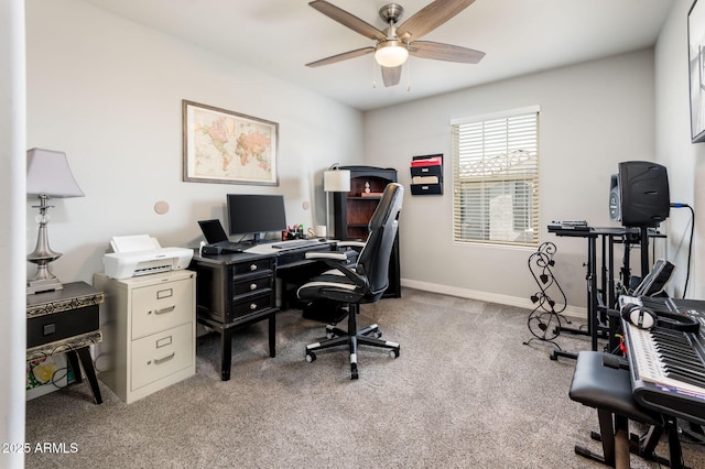 carpeted home office with ceiling fan and baseboards