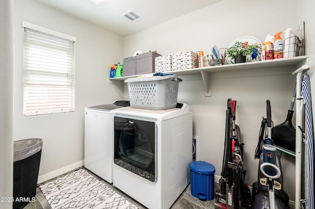 laundry area with washing machine and dryer and baseboards