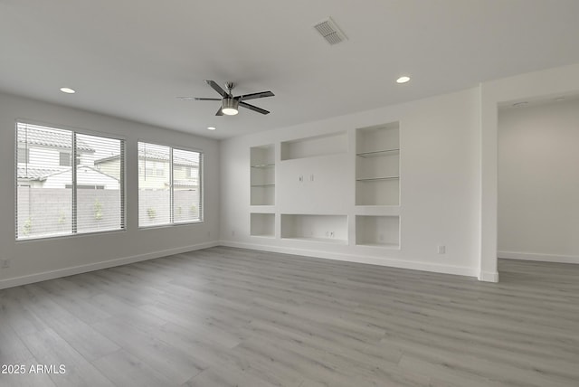 unfurnished living room with ceiling fan, light hardwood / wood-style floors, and built in features