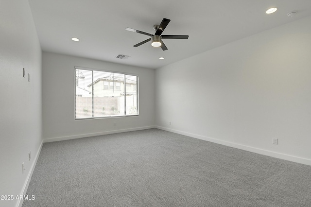 spare room featuring carpet floors and ceiling fan