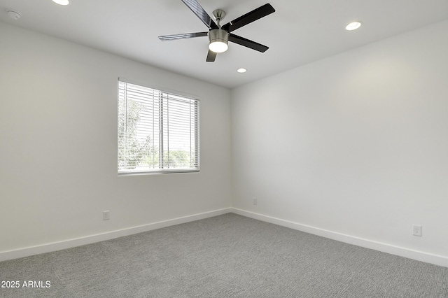 carpeted empty room featuring ceiling fan